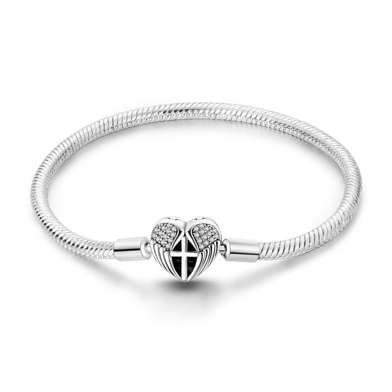 Bracelet argent croix jeune fille sur chaîne serpent avec pendentif cœur ailé pavé de zirconiums