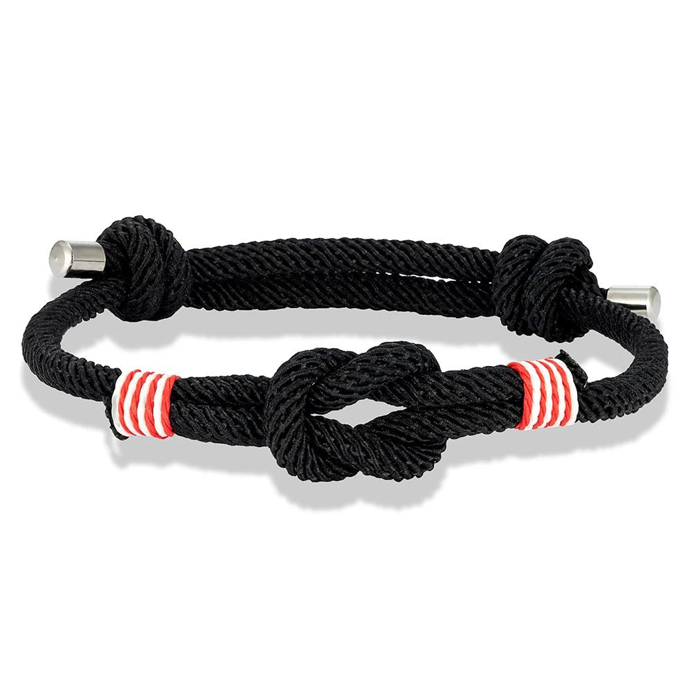 Bracelet nautique homme au cordage noir avec nœud marin central, surliures rouge-blanc et embouts acier